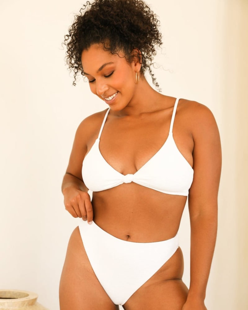Front of a model wearing a size L Seashore Bottom in White by Dippin' Daisy's Swimwear. | dia_product_style_image_id:272259